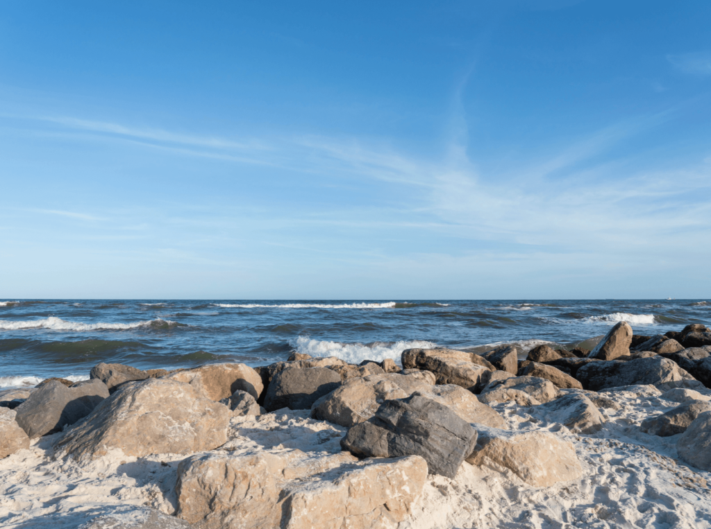 Alabama Point East is found within a state park and is a popular beach with white sand, colorful sunsets, and gentle waves.