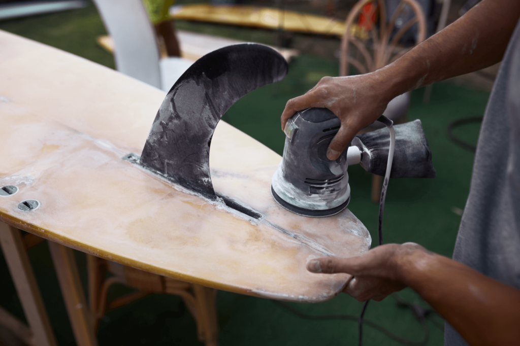 Surfboard repair in 4 simple steps: clean board, apply resin, cure resin, sand.
