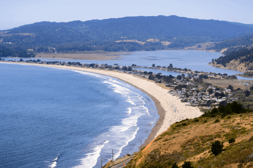 Stinson Beach is home to white-sand beaches, forested trails, and rugged red cliffs.